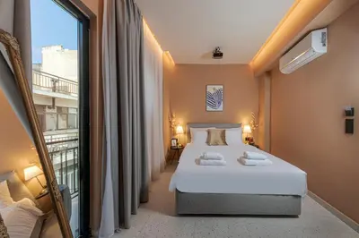 a hotel room with a bed and a balcony at Clyde Athens by Nin&Bau in Athens