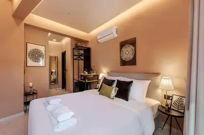 a bedroom with a white bed with towels on it at Clyde Athens by Nin&Bau in Athens