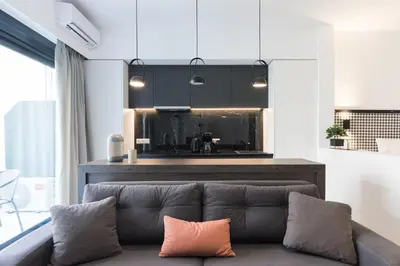 a living room with a couch and a kitchen at Voda Luxury Residence #201 - Acropolis View Rooftop in Athens