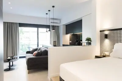 a hotel room with a bed and a couch at Voda Luxury Residence #201 - Acropolis View Rooftop in Athens