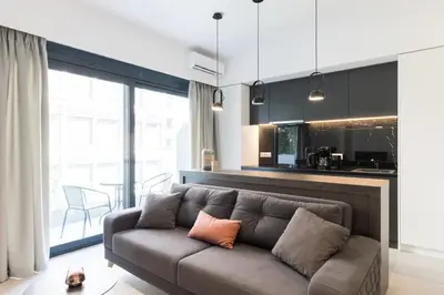 a living room with a couch and a kitchen at Voda Luxury Residence #201 - Acropolis View Rooftop in Athens