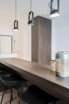 a kitchen with a wooden counter and two stools at Voda Luxury Residence #201 - Acropolis View Rooftop in Athens