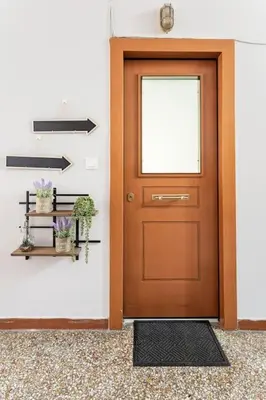 a wooden door in a hallway with plants and shelves at Acropolis View in Athens