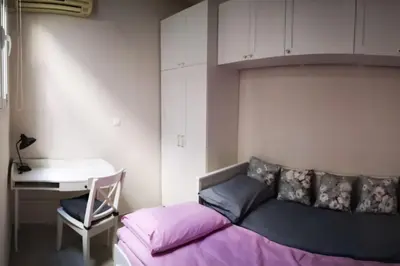 a bedroom with a bed and a desk and a desk at Acropolis View in Athens