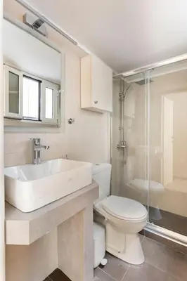 a bathroom with a sink and a toilet and a shower at Acropolis View in Athens