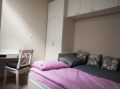 a bedroom with a bed and a desk and a chair at Acropolis View in Athens