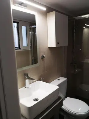a bathroom with a sink and a toilet and a mirror at Acropolis View in Athens