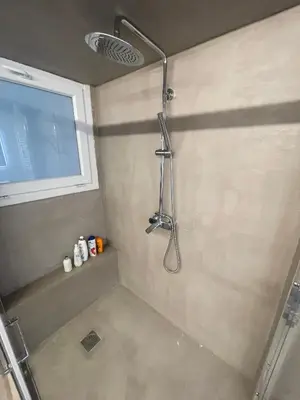 a shower with a shower head in a bathroom at PAGRATI FLAT 7 in Athens