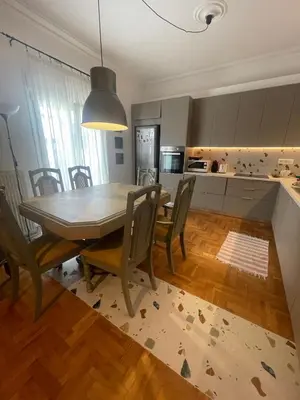 a kitchen and dining room with a table and chairs at PAGRATI FLAT 7 in Athens
