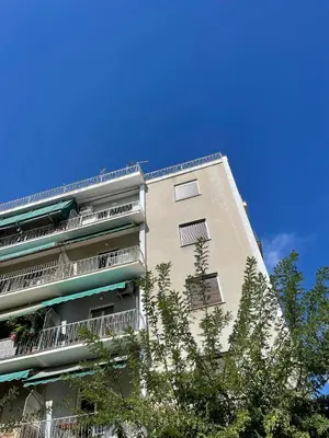 a tall apartment building with trees in front of it at PAGRATI FLAT 7 in Athens