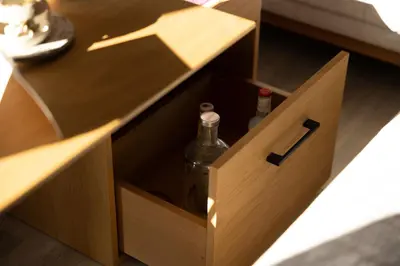 a wooden drawer with two bottles of wine in it at 