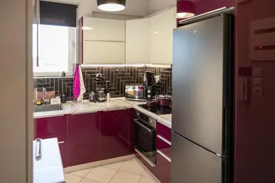 a kitchen with purple cabinets and a refrigerator at 