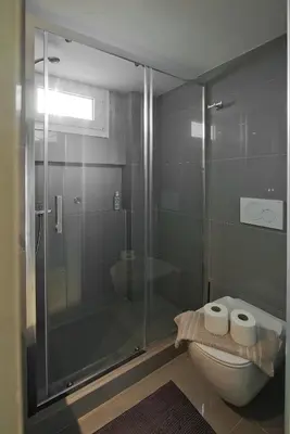 a bathroom with a glass shower and a toilet at LucyZen! Stylish Apt, Athenian Riviera, near beach in Athens