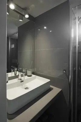 a bathroom with a sink and a shower and a mirror at LucyZen! Stylish Apt, Athenian Riviera, near beach in Athens