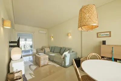 a living room with a couch and a table at LucyZen! Stylish Apt, Athenian Riviera, near beach in Athens