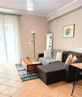 a living room with a couch and a coffee table at Elpida's house in Spáta