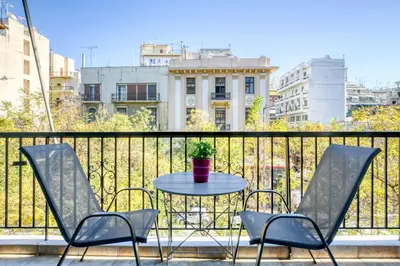 a small table and chairs on a balcony at Nemesis - Elegant apartment in Athens in Athens