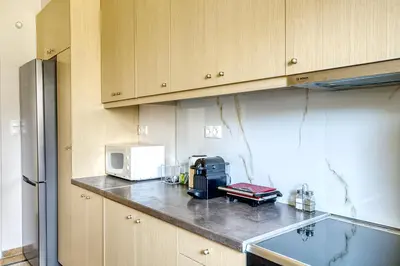 a kitchen with a counter top with a microwave at Nemesis - Elegant apartment in Athens in Athens