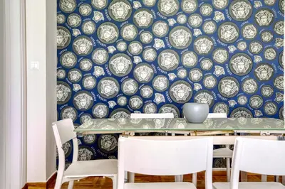 a dining room with a blue and white wallpaper at Nemesis - Elegant apartment in Athens in Athens