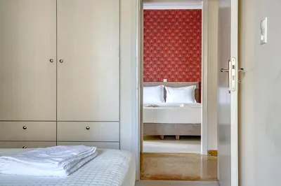 a bedroom with a bed and a door with a mirror at Nemesis - Elegant apartment in Athens in Athens