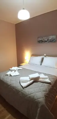 a bedroom with a bed with towels on it at Modern home, 6' from the Metro in Athens