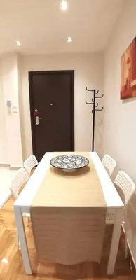 a dining room table with a plate on top of it at Modern home, 6' from the Metro in Athens
