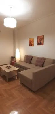 a living room with a couch and a table at Modern home, 6' from the Metro in Athens