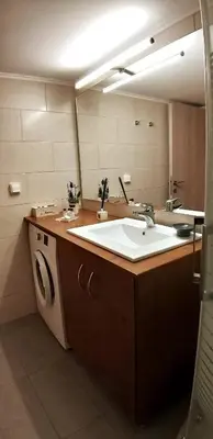 a bathroom with a sink and a large mirror at Modern home, 6' from the Metro in Athens