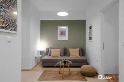 a living room with a couch and a table at Aether Apartment by LobbySquare in Athens