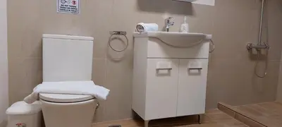 a bathroom with a toilet and a sink at Luxury Apartment 12BD 5BATH in Athens