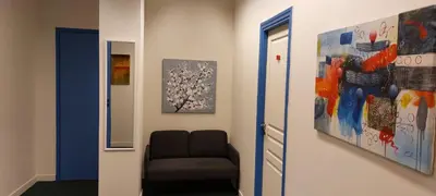 a room with a chair and a painting on the wall at Luxury Apartment 12BD 5BATH in Athens