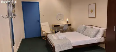 a room with a bed with a blue door and a desk at Luxury Apartment 12BD 5BATH in Athens