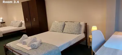 a small room with two beds with towels on them at Luxury Apartment 12BD 5BATH in Athens