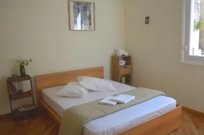 a bedroom with a bed with two towels on it at SUNNY QUIET APATMENT AT LYCABETOUS in Athens