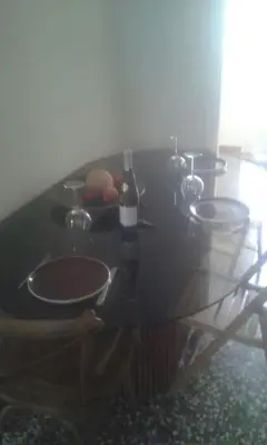 a table with three sinks and a bottle of wine at SUNNY QUIET APATMENT AT LYCABETOUS in Athens
