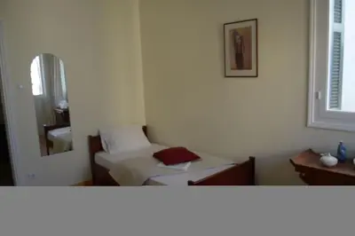 a small room with a bed and a mirror at SUNNY QUIET APATMENT AT LYCABETOUS in Athens