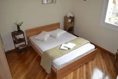 a bedroom with a bed with two towels on it at SUNNY QUIET APATMENT AT LYCABETOUS in Athens