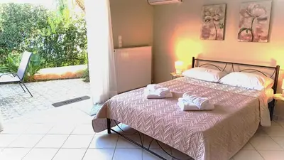 a bedroom with a bed with two towels on it at Apartment MARE CALMO by the sea. in Porto Rafti