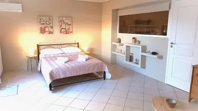 a bedroom with a bed and a tiled floor at Apartment MARE CALMO by the sea. in Porto Rafti