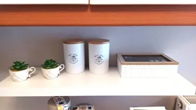 a shelf with three cups and a box on it at Apartment MARE CALMO by the sea. in Porto Rafti
