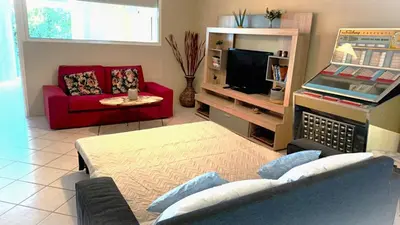 a living room with a couch and a tv at Apartment MARE CALMO by the sea. in Porto Rafti