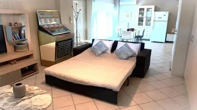 a living room with a couch and a video game at Apartment MARE CALMO by the sea. in Porto Rafti
