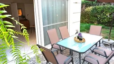 a patio with a table and chairs on a patio at Apartment MARE CALMO by the sea. in Porto Rafti