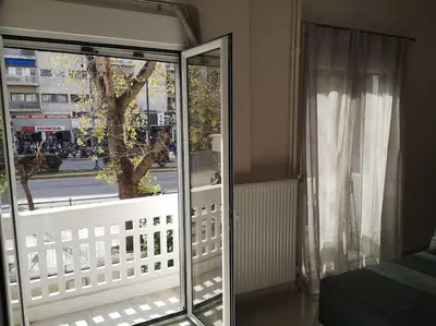 a bedroom with a sliding glass door to a balcony at Athens Innova Apartment I in Athens