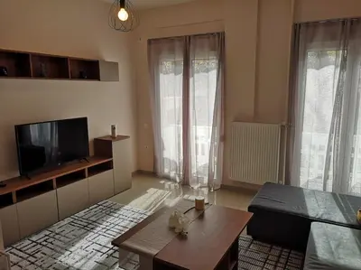a living room with a tv and a coffee table at Athens Innova Apartment I in Athens