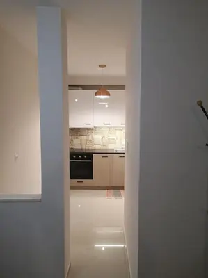 a kitchen with white cabinets and a stove top oven at Athens Innova Apartment I in Athens