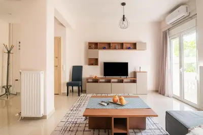 a living room with a table and a tv at Athens Innova Apartment I in Athens