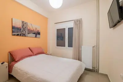 a bedroom with a white bed and a window at Athens Innova Apartment I in Athens