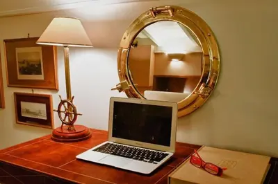 a laptop computer sitting on a table with a mirror at Acropolis Luxury House in Athens