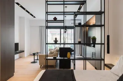 a room with a bed and a desk with a couch at Voda Luxury Residence #301 - Acropolis View Rooftop in Athens